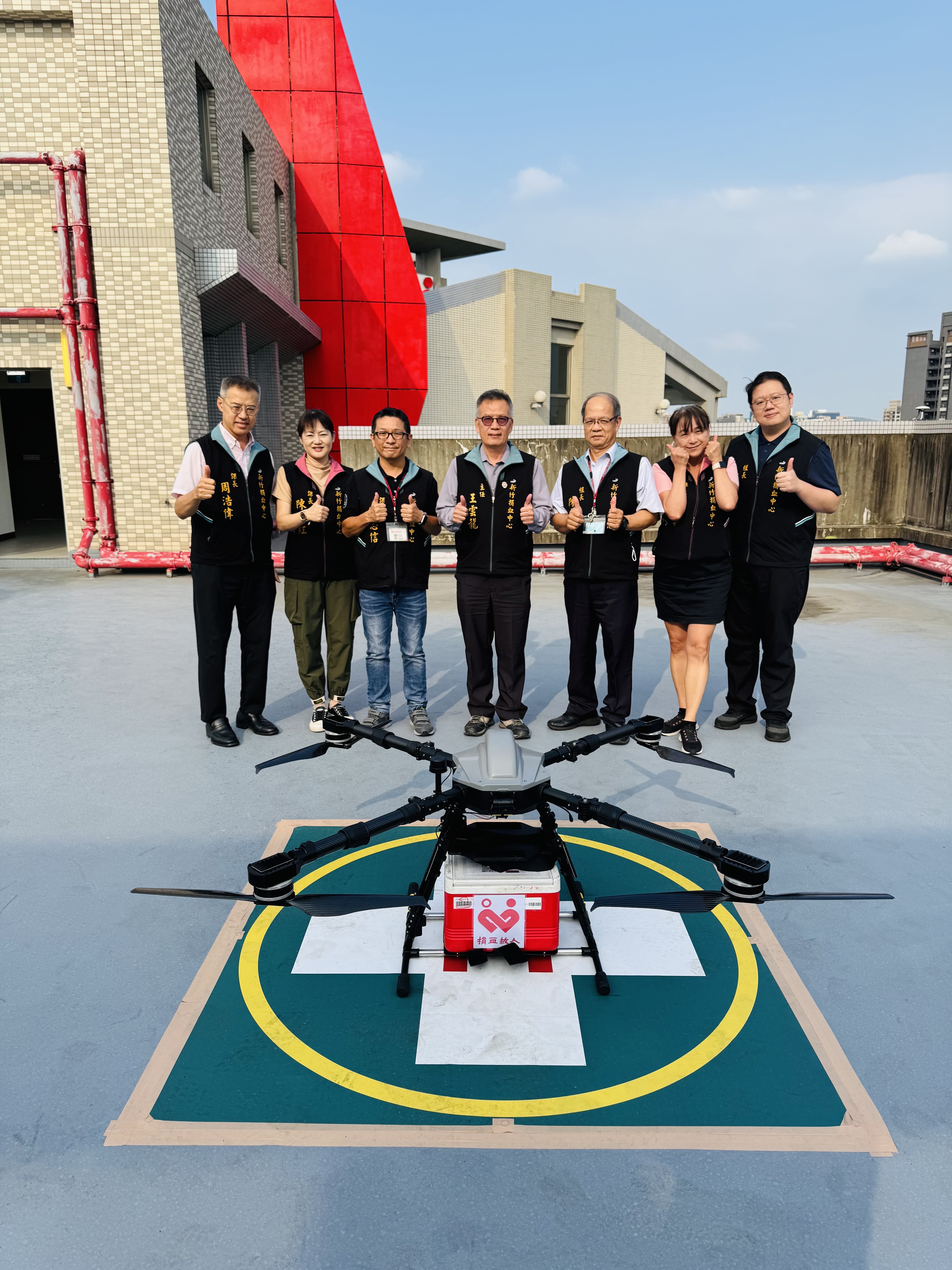 Director Wang Yun-Long (center) and colleagues posing with the drone
