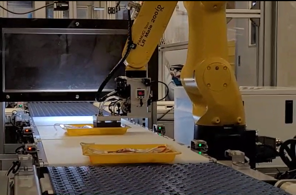 Automated verification and labeling system machine arm applying labels to blood bags